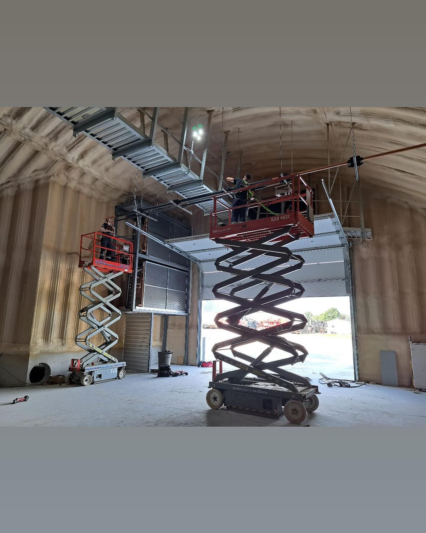 A refrigeration installation in progress inside an arch-roof building, photographed by Dundas Mechanical (Instagram, January 2025)